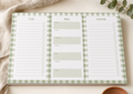 A three-panel notepad with a sage green and white gingham border, featuring sections labeled To Do, Menu, and Shopping. The notepad is styled flat-lay on a light beige surface with a textured cream fabric and eucalyptus leaves.