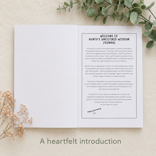 An open white journal spread showing a printed welcome page titled 'Welcome to Auntie's Unfiltered Journal' with body text and a signature, styled on a light beige surface with eucalyptus leaves and dried flowers. Large text below reads 'A heartfelt introduction.