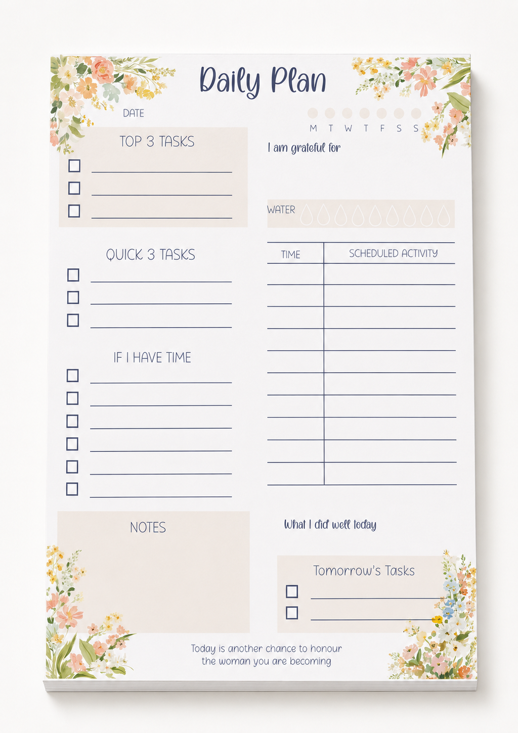 A daily planner notepad with floral watercolor corner designs and sections for tasks, gratitude, water, scheduled activity, notes, and tomorrow's tasks, shown on a clean white background.