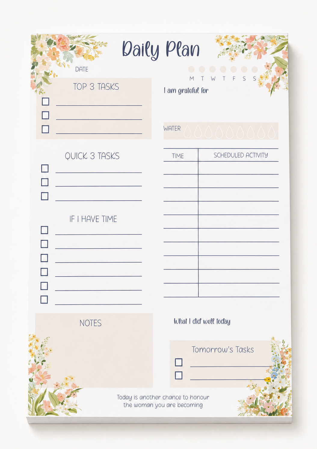 A daily planner notepad with floral watercolor corner designs and sections for tasks, gratitude, water, scheduled activity, notes, and tomorrow's tasks, shown on a clean white background.