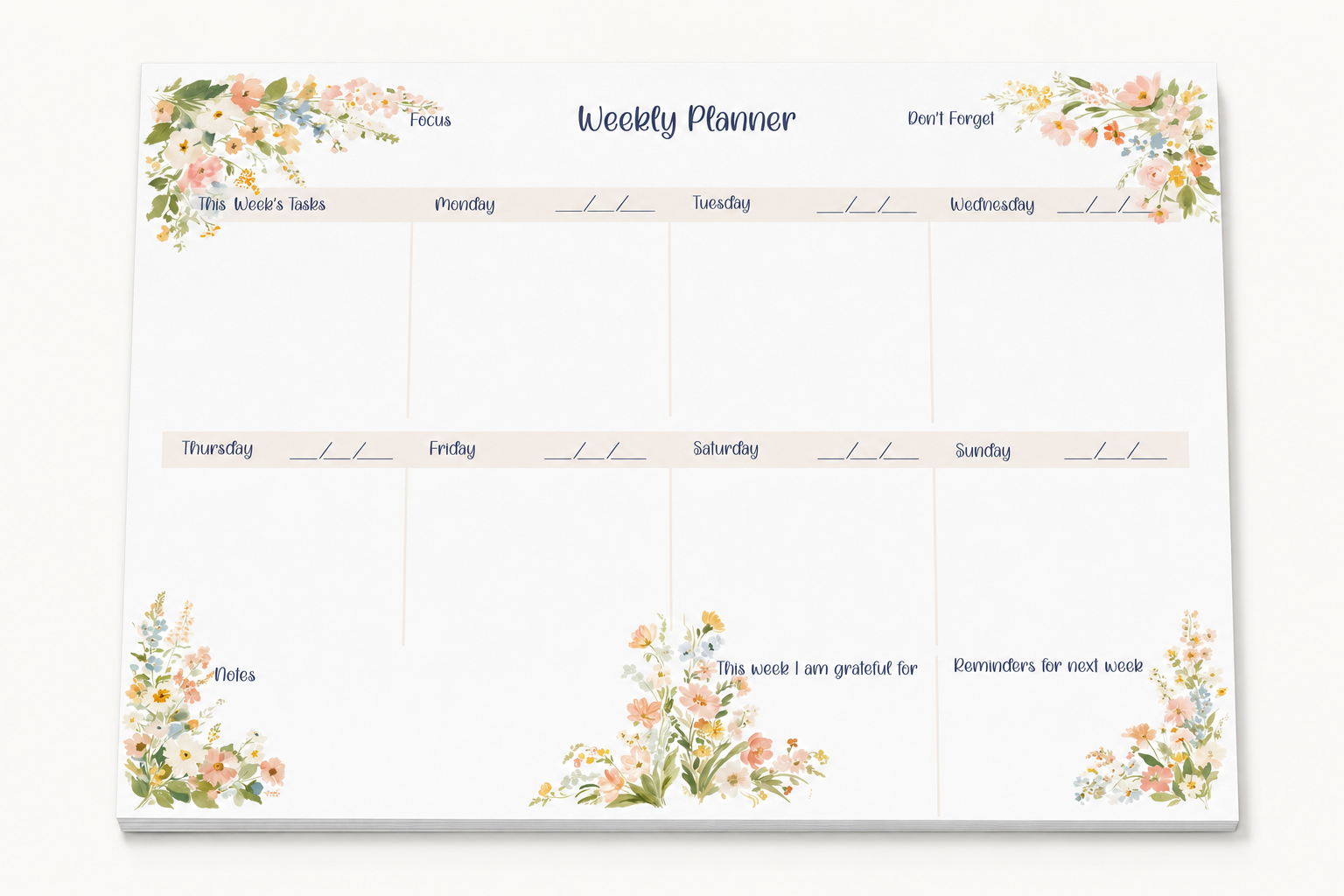 A weekly planner notepad with a white background, decorated with pastel watercolor floral designs in the corners. The top section has columns for Focus, Don't Forget, and other days of the week, with additional writing spaces below.